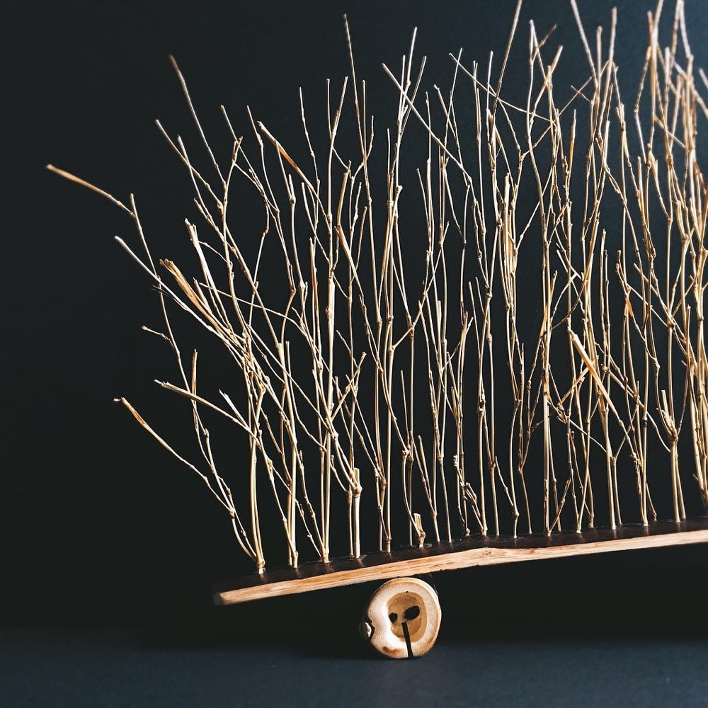 Bamboo branches on a bamboo base by Nagi Studio